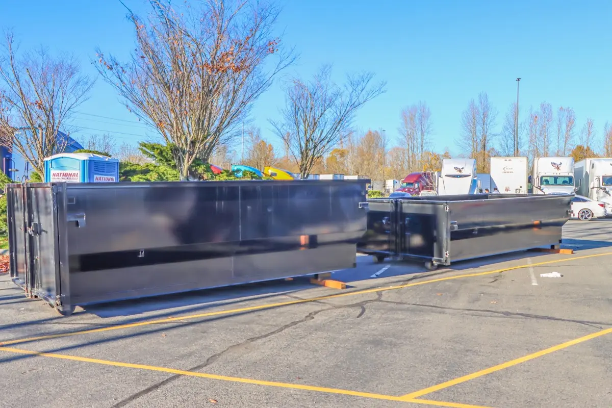 Professional dumpster rental service with roll-off container on residential driveway in Tucson Estates